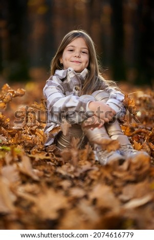 Similar – Foto Bild fröhlich lustiges Kind Mädchen isst frischen Apfel im Herbst