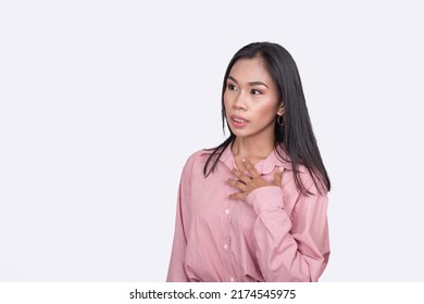 Candid Scene Of A Filipina Woman In A Pink Blouse Shocked By A Rude Comment. An Emotionally Sensitive Woman. Posing Against A White Backdrop.