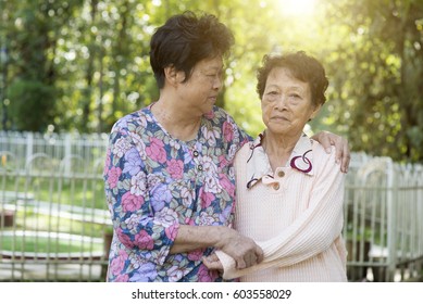 Candid Shot Of Asian Elderly Women At Outdoor Park In The Morning.