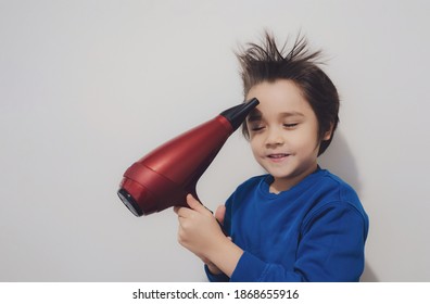 Candid Shot, Cute Kid Drying His Hair With Hair Dryer, Cheerful 6 Years Old Boy Try To Making His Hair Like A Crazy Expression, Flying Hair, Positive And  Healthy Children Concept