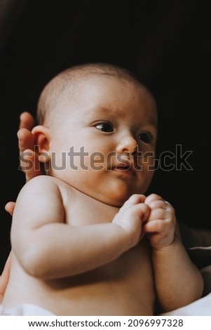 Similar – Nude baby posing in her mother’s arms