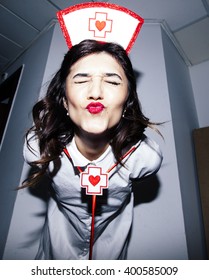 Candid Snapshot Of A Young Adult Woman Disguised As A Nurse Goofing Off In Front Of The Camera.