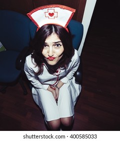 Candid Snapshot Of A Young Adult Woman Disguised As A Nurse Goofing Off In Front Of The Camera.