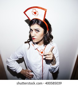 Candid Snapshot Of A Young Adult Woman Disguised As A Nurse Goofing Off In Front Of The Camera.