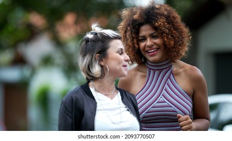 Candid Two Diverse Women Walking Together Outside In Street Laughing And Smiling