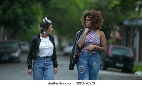 Candid Two Diverse Women Walking Together Outside In Street Laughing And Smiling