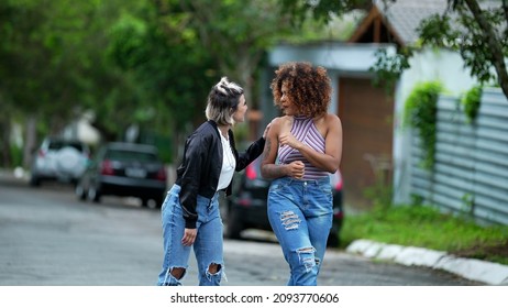 Candid Two Diverse Women Walking Together Outside In Street Laughing And Smiling