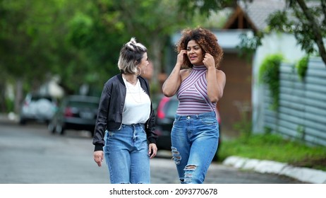 Candid Two Diverse Women Walking Together Outside In Street Laughing And Smiling