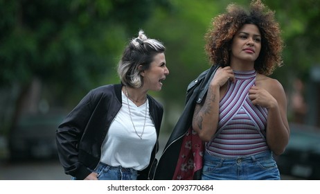 Candid Two Diverse Women Walking Together Outside In Street Laughing And Smiling