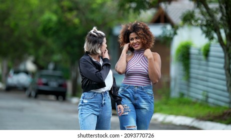 Candid Two Diverse Women Walking Together Outside In Street Laughing And Smiling