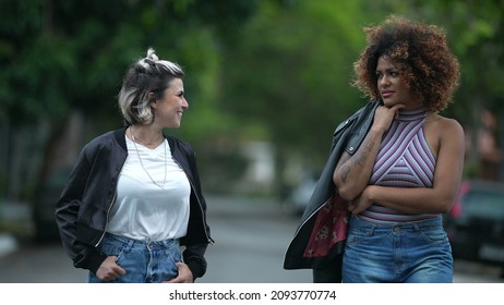 Candid Two Diverse Women Walking Together Outside In Street Laughing And Smiling