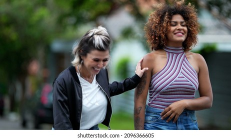 Candid Two Diverse Women Walking Together Outside In Street Laughing And Smiling