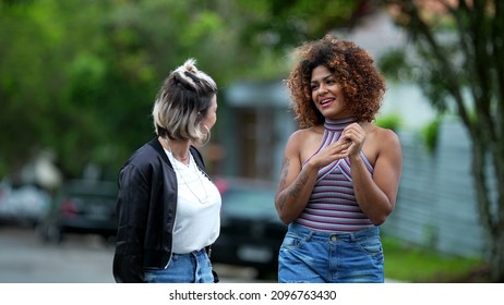 Candid Two Diverse Women Walking Together Outside In Street Laughing And Smiling