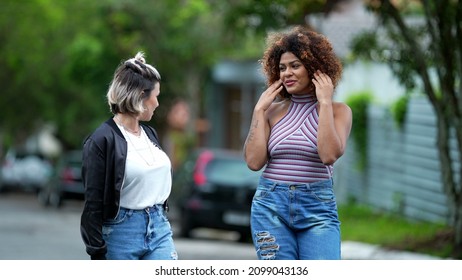 Candid Two Diverse Women Walking Together Outside In Street Laughing And Smiling