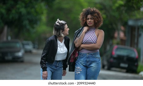 Candid Two Diverse Women Walking Together Outside In Street Laughing And Smiling