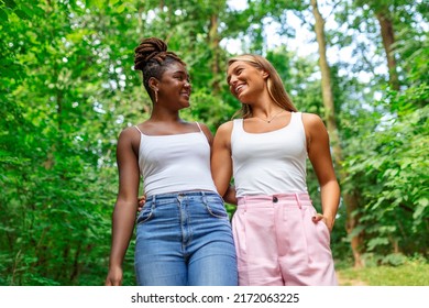 Candid Two Diverse Women Walking Together Outside Laughing And Smiling