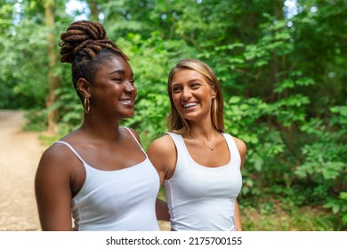 Candid Two Diverse Women Walking Together Outside Laughing And Smiling