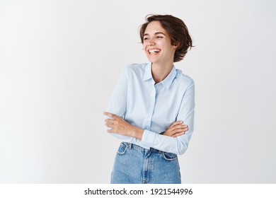 Candid Young Office Woman In Blue Collar Shirt, Laughing And Smiling Happy, Looking Aside At Empty Space Logo, Standing On White Background.