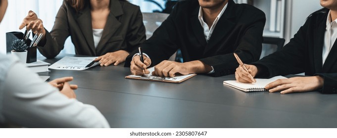 Candidate and interviewers discuss work experience and qualifications in friendly job interview at corporate office. HR team evaluates job application while interviewee explaining profile. Prodigy