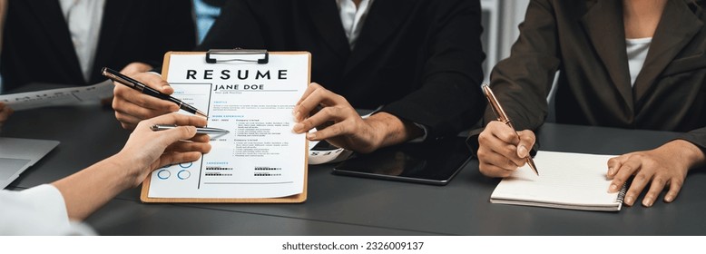 Candidate and interviewers discuss work experience and qualifications in friendly job interview at corporate office. HR team evaluates job application while interviewee explaining profile. Prodigy