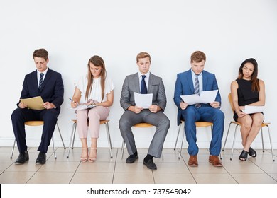 Candidates waiting for job interviews, full length, front