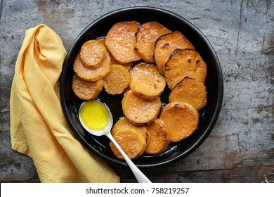 Candied yams, or sweet potatoes.  Top view over wooden table.