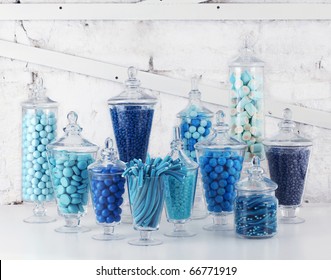 Candies in bowls on white background