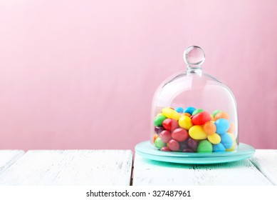 Candies In Glass Bell Jar On White Table