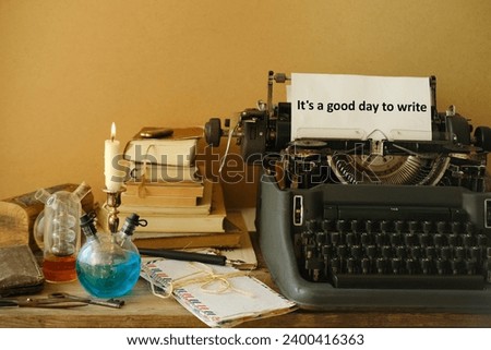 candle burning in candlestick, stack old books, letters, vintage typewriter with good day to write, creative process and literary creation, atmosphere journalism and reportage, antiques and collecting