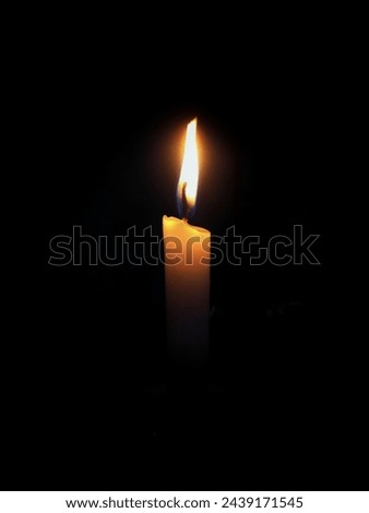 Candle burning in the dark