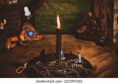 Candle burns on the altar, candles magic, clean aura and negative energy, wicca concept - Shutterstock ID 2215997455