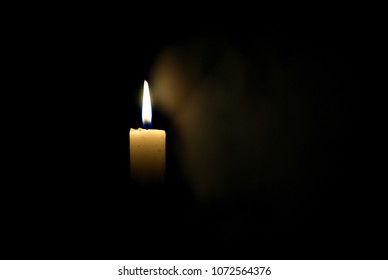 Candle in the dark. Smoke from a candle. - Shutterstock ID 1072564376