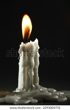 Candle flame close up on a dark background. Melted Wax Candle light border design. Burning at Night, Darkness 