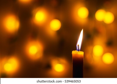 Candle Flame Light At Night With Bokeh On Dark Background.