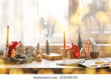 Candle holders with Christmas decor, cup of tea and cookies on counter in kitchen - Powered by Shutterstock