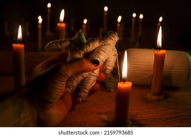 Candle light in the dark and curse doll, candle light ceremony - Shutterstock ID 2159793685
