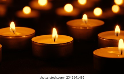 Candle light and flame on black background