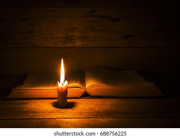 Candle Light With Holy Bible On Wooden Table In The Night , Dark Room With Out Electric Light, Copy Space