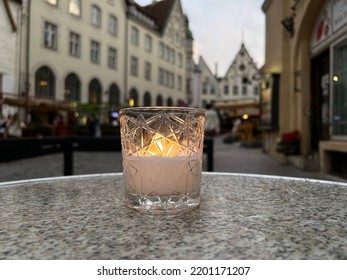 Candle Light On Street Table Top In Rainy City In Medieval Tallinn Old Town 