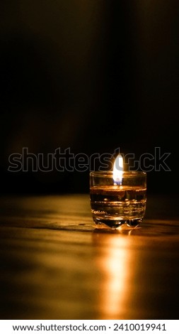 Candle light over the table in the dark