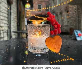 Candle Light  And  Rainy Autumn Leaves On Street Cafe Table In Evening  Rainy City Blurred Bokeh Light Tallinn Old Town