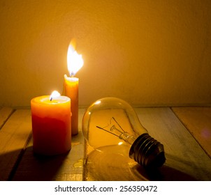 candle light shine on incandescent bulb, no electricity makes electrical equipment useless