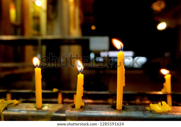 Candle light,\
yellow candles, religious\
beliefs