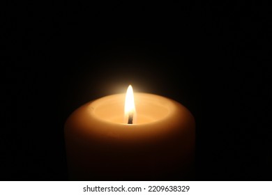 Candle Lit In A Dark Room. 