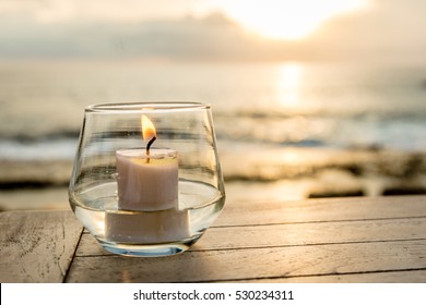 Candle on a table at an ocean view cafe, Sunset Point, Nusa Lembongan, Indonesia. Concept of calmness, romance, serenity. 