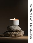 Candle product for aroma therapy. Meditation in spiritual zen scenery, aromatic candles on rocks. Relaxing candles spa and wellness background.