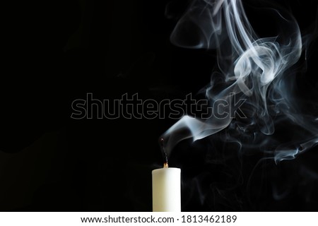 Candle and smoke extinguished Smoke Art on black background