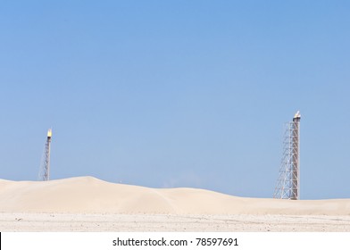 A Candle Tower Burning Off Excess Gas At An Oil Refinery In The Desert.