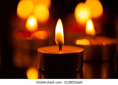 candle,Burning candles in darkness ,Many candles burn with a shallow depth of field.