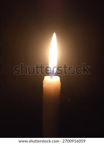 Candlelight in the darkness of night